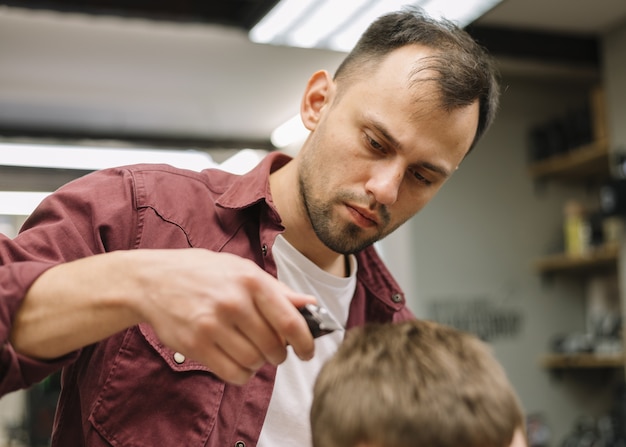 Foto gratuita estilista dando un corte de pelo a un cliente