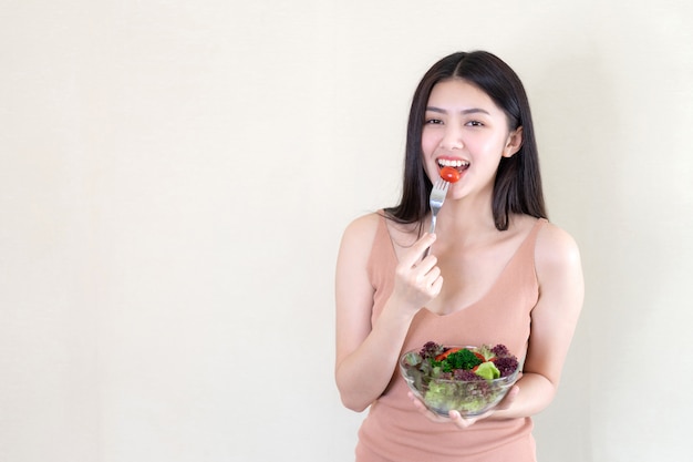 Estilo de vida belleza hermosa mujer Asiática linda niña sentirse feliz disfrutar comiendo comida dieta ensalada fresca para una buena salud en la mañana