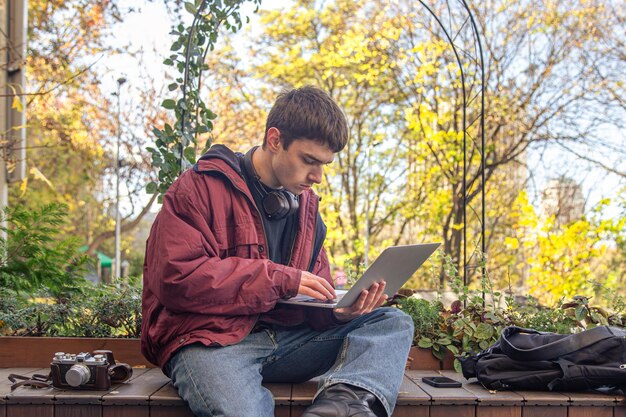 Un estudiante estudia usando una computadora portátil un estudiante masculino estudiando en línea