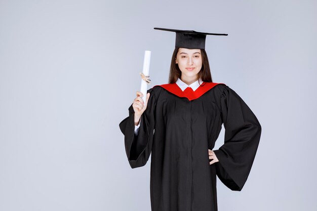 Estudiante graduada con celebración de diploma de graduación universitaria exitosa. Foto de alta calidad