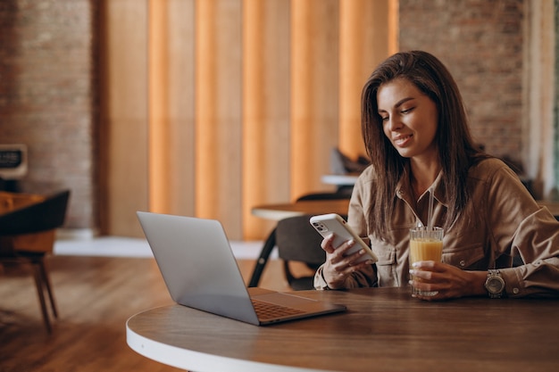 Estudiante mujer estudiando en un portátil en un café