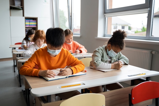 Estudiantes aprendiendo en la escuela en su salón de clases.