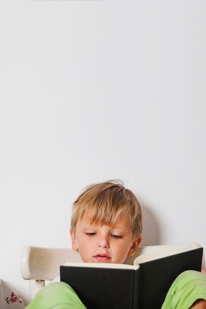 Excited boy reading book