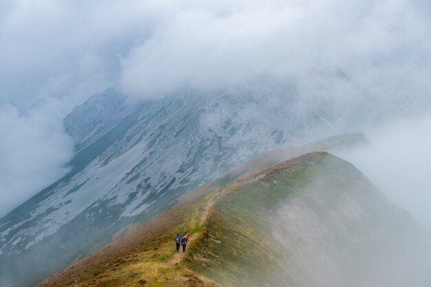 Excursionistas subiendo una montaña alta.