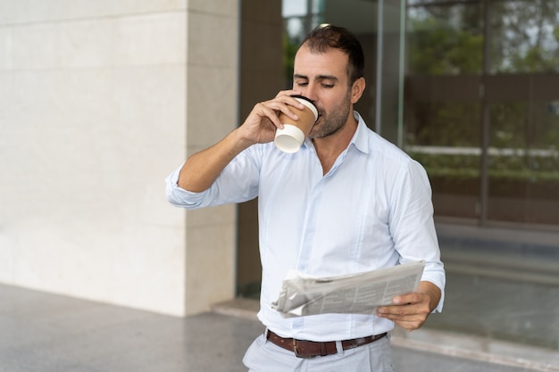 Experto en negocios alegre disfrutando de café