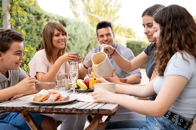 Familia almorzando juntos al aire libre