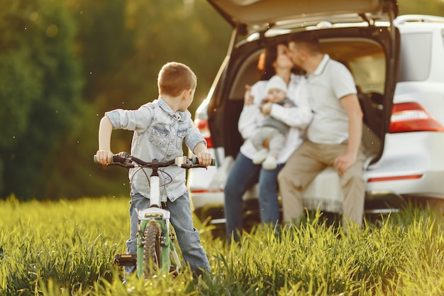 Familia en un bosque de verano junto al tronco abierto