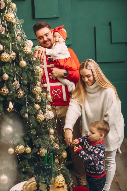 Familia en casa cerca del árbol de navidad