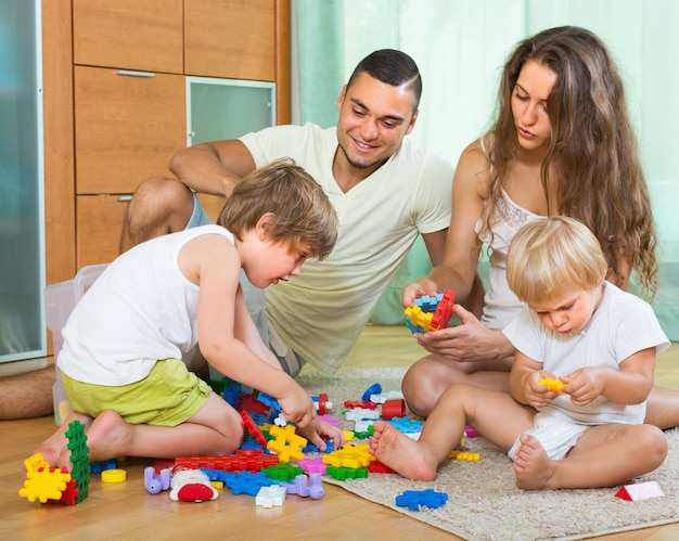 Familia de cuatro en casa con juguetes