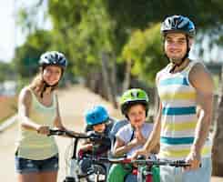 Foto gratuita familia de cuatro personas en bicicleta en la calle