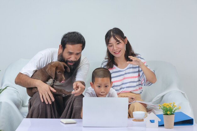 La familia está usando el tiempo de relajación juntos en el sofá de casa.