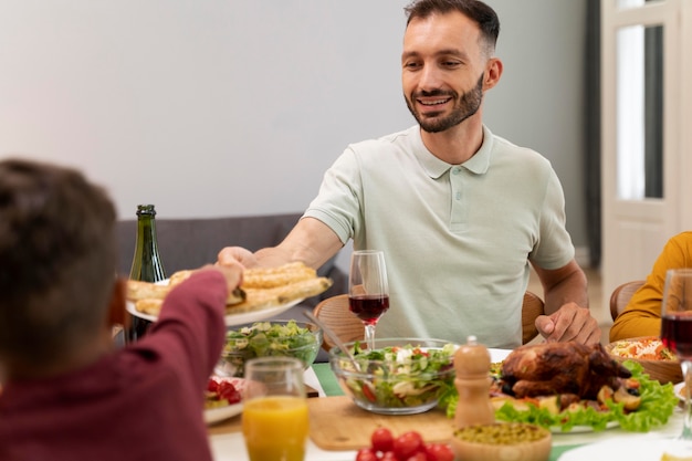 Foto gratuita familia feliz cenando juntos