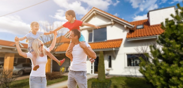 Familia feliz cerca de casa nueva. concepto de bienes raíces.