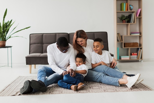 Familia feliz divirtiéndose juntos en el piso