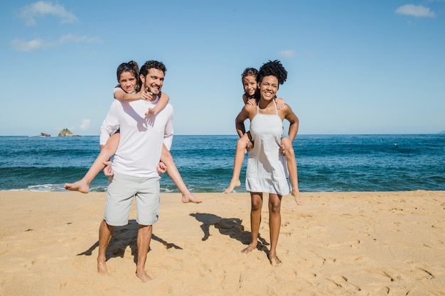 Familia feliz jugando en la playa