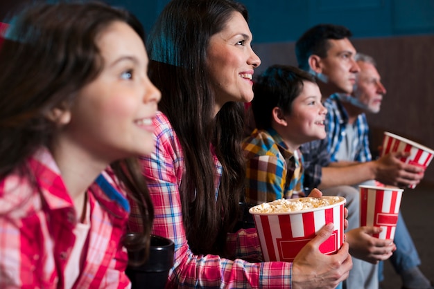 Familia feliz sentada en cine