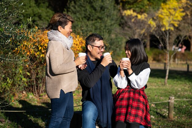 Familia feliz de tiro medio con bebidas