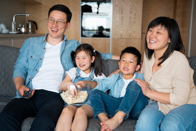 Familia feliz de tiro medio en el sofá