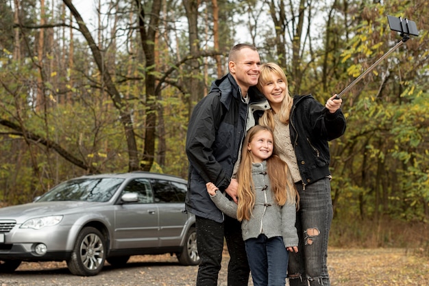 Familia feliz tomando una selfie en la naturaleza