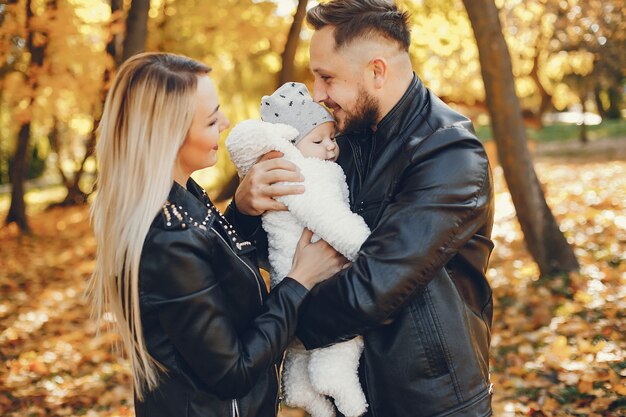 Familia con hija en un parque de otoño