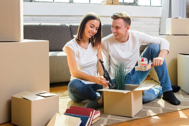 Familia joven empacando sus cosas en cajas