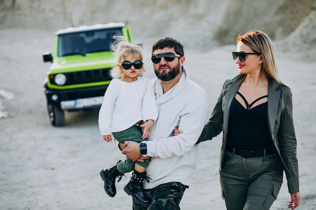 Familia joven con hija pequeña viajando en coche