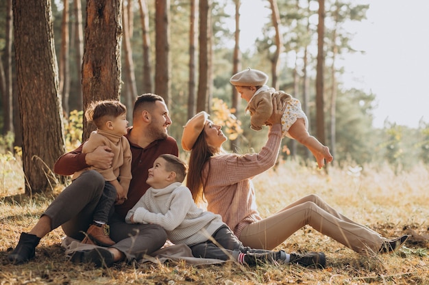 Familia joven con niños haciendo un picnic en el parque