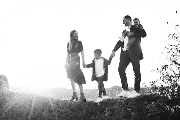 Familia joven con pequeño hijo caminando en el parque