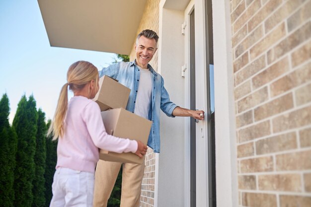 Familia joven que se siente emocionado mientras se muda a una nueva casa