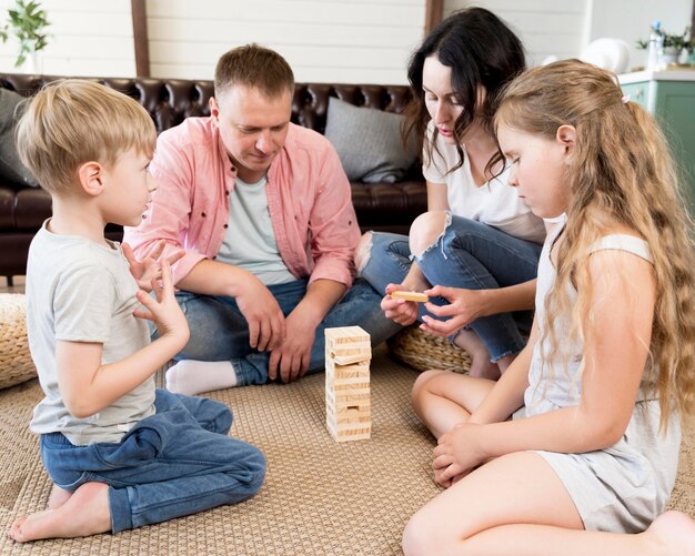 Familia jugando jenga en la sala de estar