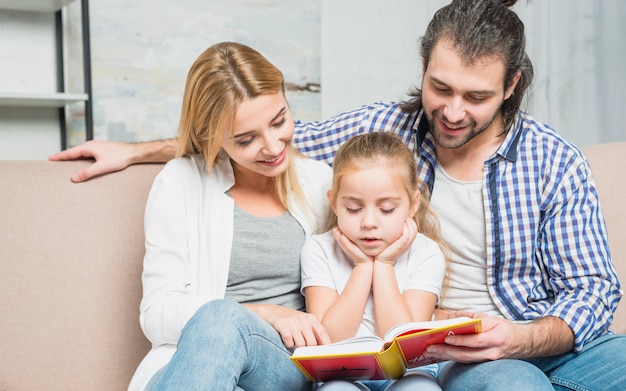 Familia leyendo en el sofá