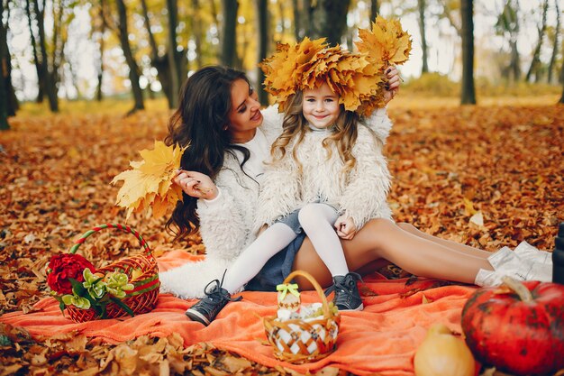 Familia linda y elegante en un parque de otoño