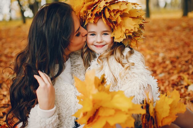 Familia linda y elegante en un parque de otoño