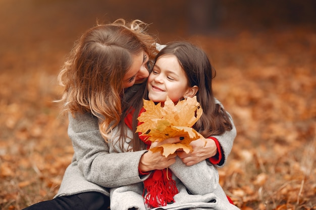 Familia linda y elegante en un parque de otoño