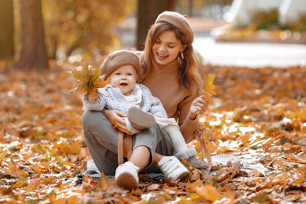 Familia linda y elegante en un parque de otoño