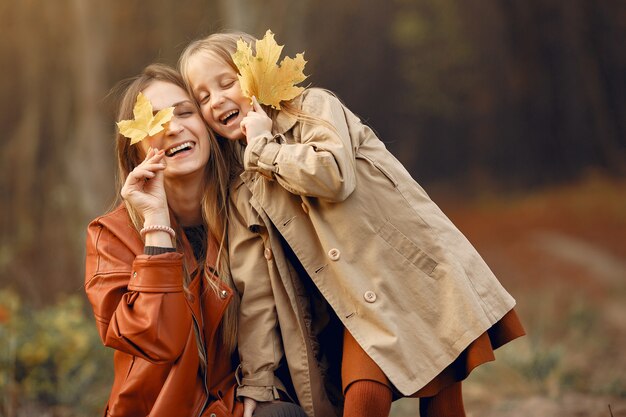 Familia linda y elegante en un parque de otoño