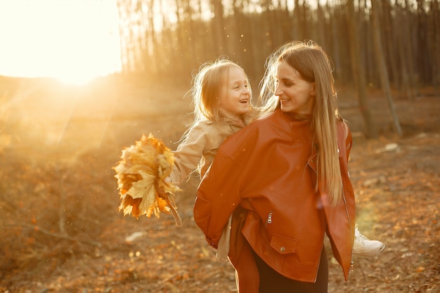 Familia linda y elegante en un parque de otoño