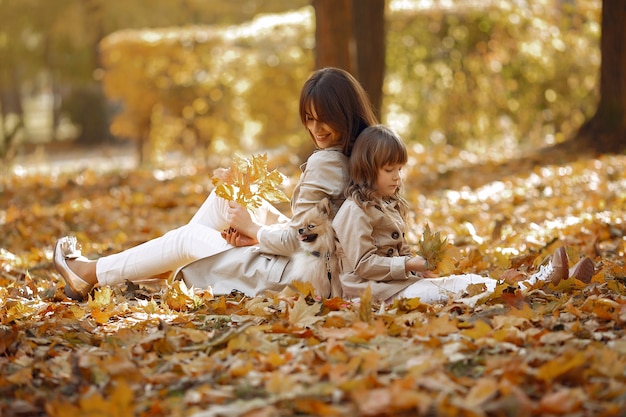 Familia linda y elegante en un parque de otoño