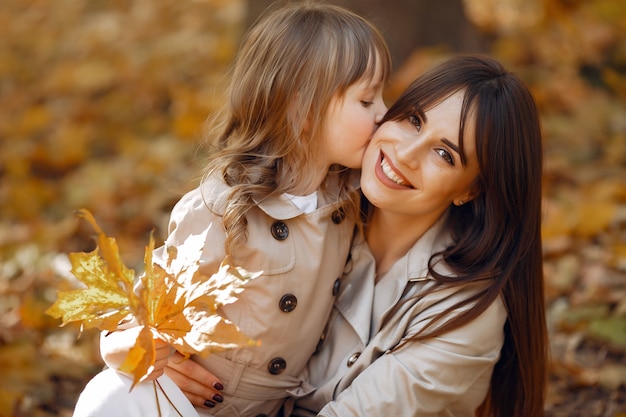 Familia linda y elegante en un parque de otoño