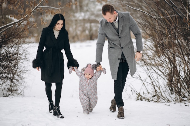 Familia en el parque en invierno con hija