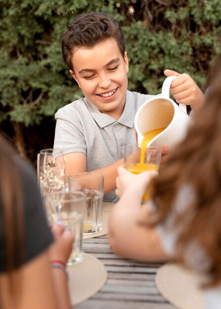 Familia pasar tiempo juntos al aire libre y beber jugo de naranja