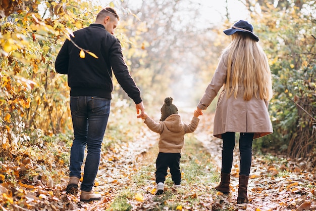 Familia con un pequeño hijo en el parque otoño