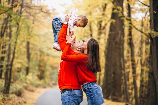 Familia con un pequeño hijo en el parque otoño