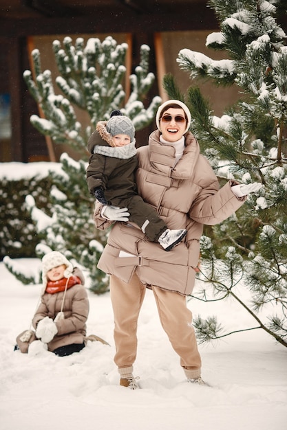 Foto gratuita familia en ropa de invierno de vacaciones en bosque nevado