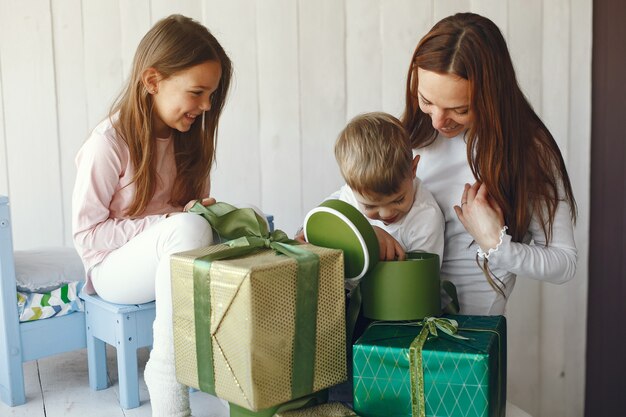 Familia sentada en casa con regalos