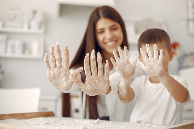 Familia sentada en una cocina y cocinar la masa para galletas