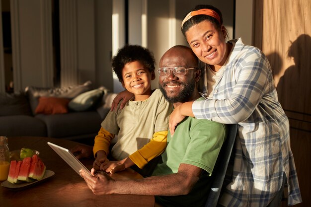 Familia sonriente de tiro medio con tableta