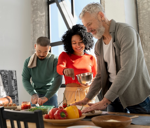 Familia de tiro medio cocinando deliciosa pizza