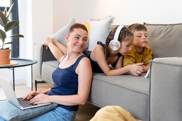 Familia de tiro medio con portátil en el interior