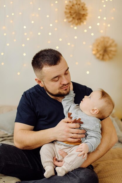 Familias retrato de feliz joven madre y padre con niño posando en el interior del hogar